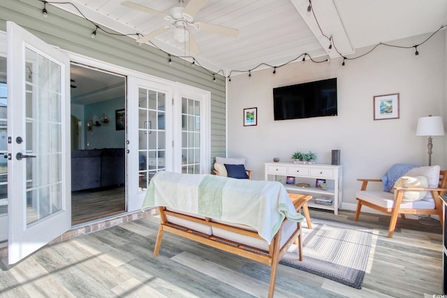 sunroom featuring french doors and a ceiling fan