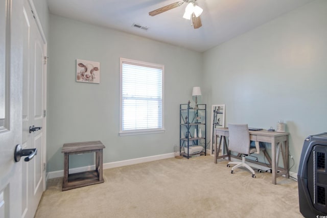 home office with carpet floors, visible vents, baseboards, and a ceiling fan