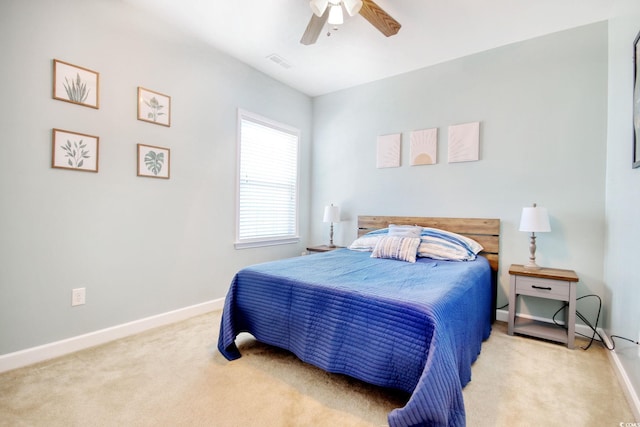 carpeted bedroom featuring visible vents, ceiling fan, and baseboards