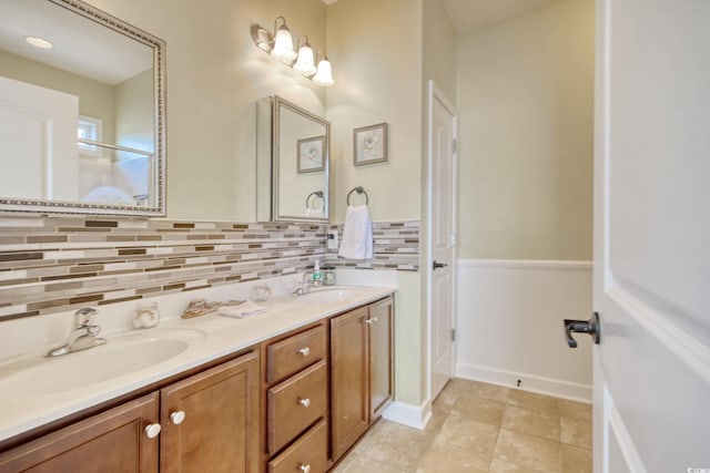 full bathroom with double vanity, decorative backsplash, and a sink