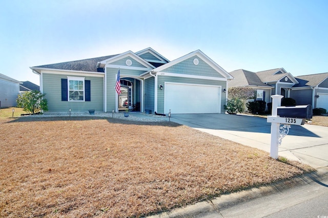 single story home featuring a front lawn, concrete driveway, and an attached garage