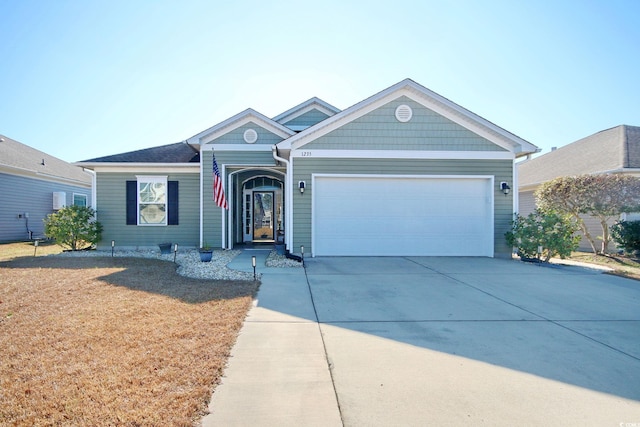 ranch-style house featuring a garage, driveway, and a front yard