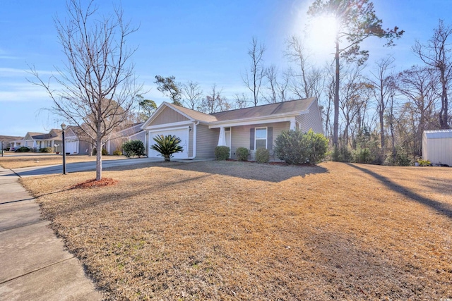 ranch-style house featuring an attached garage, a front lawn, and concrete driveway