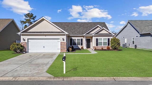 view of front of home featuring central AC unit, a garage, and a front lawn