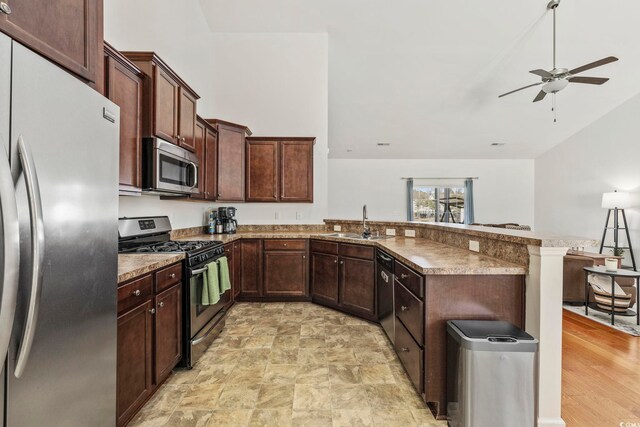 kitchen featuring sink, light hardwood / wood-style flooring, ceiling fan, high vaulted ceiling, and stainless steel dishwasher