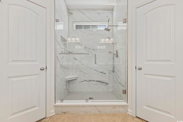 bathroom with a shower with shower door