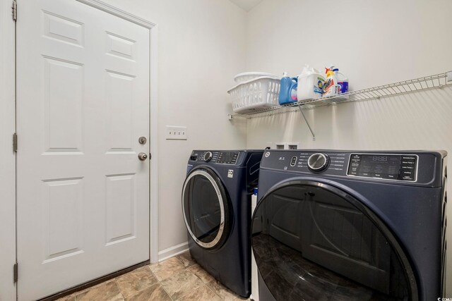 washroom with washing machine and clothes dryer