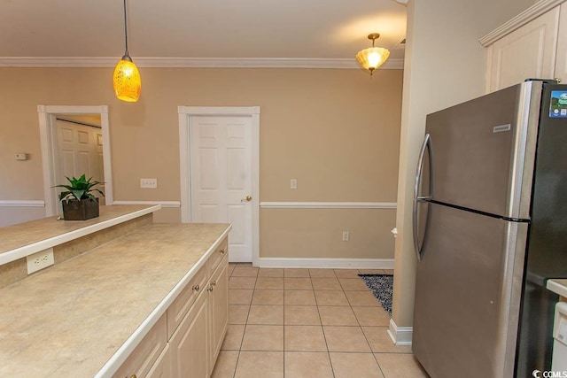 kitchen featuring hanging light fixtures, crown molding, stainless steel fridge, and light tile patterned flooring