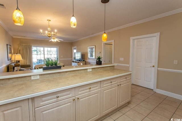 kitchen featuring hanging light fixtures, crown molding, and light tile patterned floors