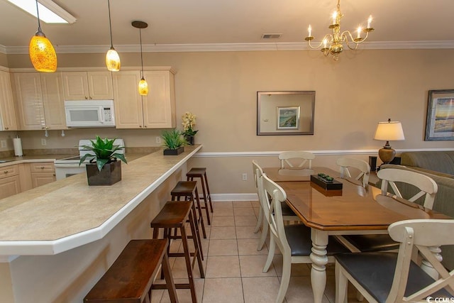 tiled dining space with ornamental molding and an inviting chandelier