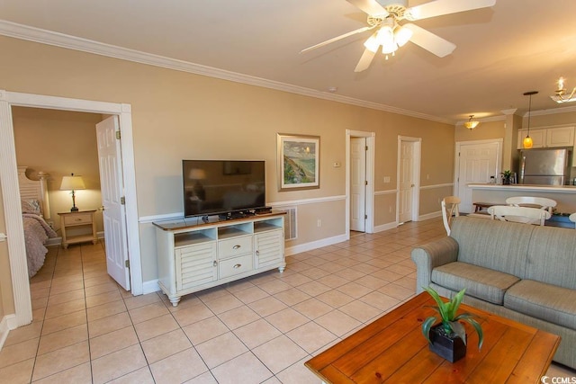 tiled living room with ornamental molding and ceiling fan