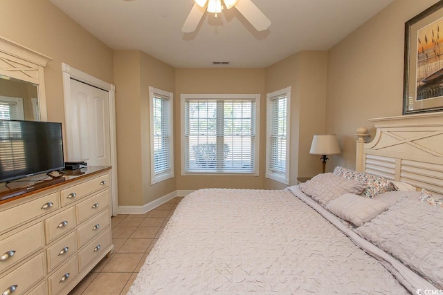 bedroom with ceiling fan and light tile patterned floors