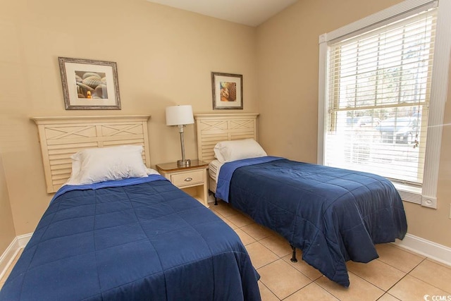 tiled bedroom with multiple windows