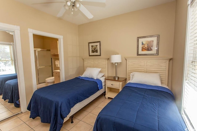 tiled bedroom featuring ceiling fan and ensuite bathroom