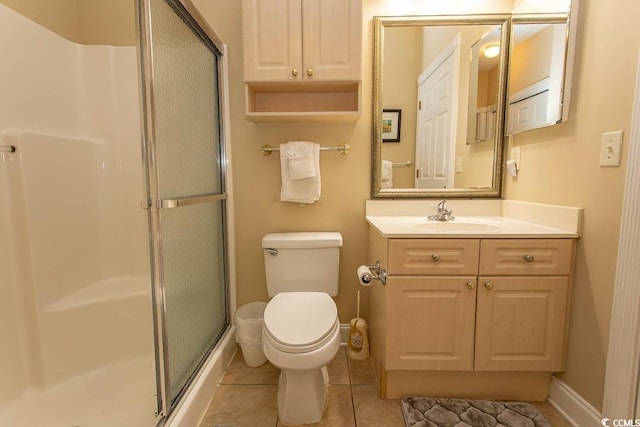 bathroom featuring vanity, an enclosed shower, tile patterned floors, and toilet