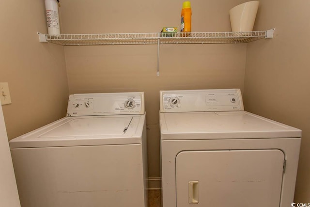 clothes washing area with washing machine and dryer