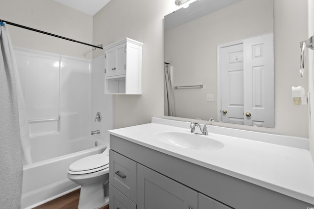 full bathroom featuring hardwood / wood-style flooring, shower / tub combination, vanity, and toilet