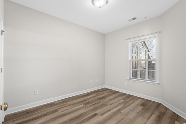 spare room featuring hardwood / wood-style flooring