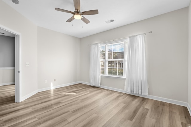 spare room with ceiling fan and light wood-type flooring