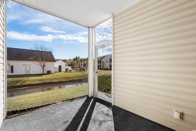 unfurnished sunroom with a water view