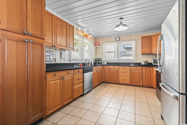 kitchen featuring light tile patterned flooring, stainless steel appliances, and sink