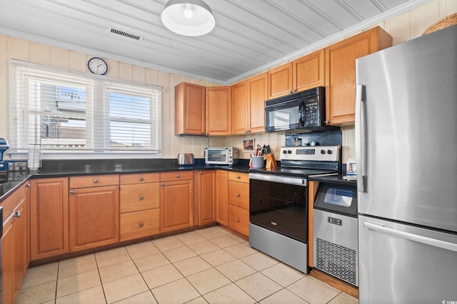 kitchen with stainless steel appliances, crown molding, and light tile patterned floors