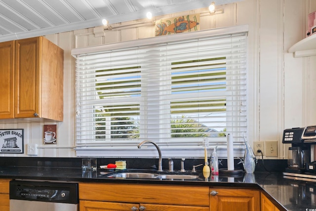 kitchen featuring dishwasher, sink, and ornamental molding