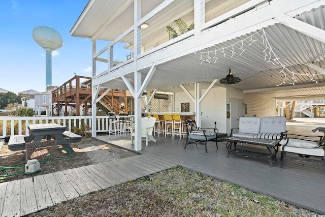 exterior space featuring an outdoor bar and ceiling fan