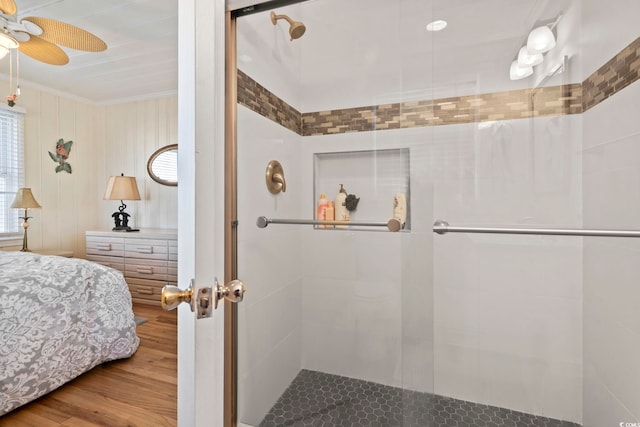 bedroom with crown molding, wood-type flooring, and ceiling fan