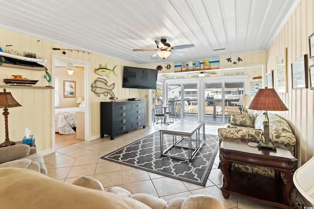 tiled living room featuring crown molding and ceiling fan