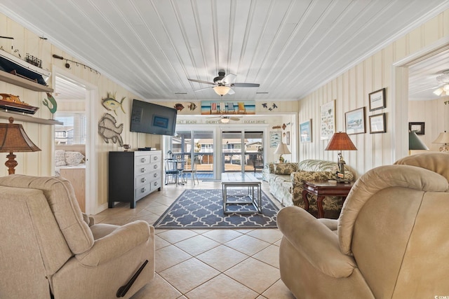 living room featuring ceiling fan, a wealth of natural light, and light tile patterned floors