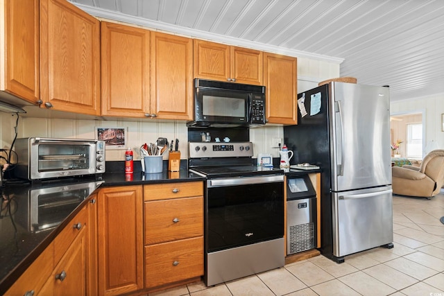 kitchen featuring light tile patterned floors and stainless steel appliances