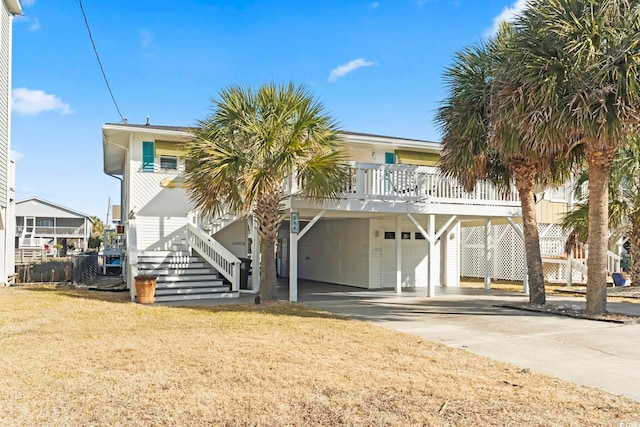 view of front of house featuring a garage, a front lawn, and a carport