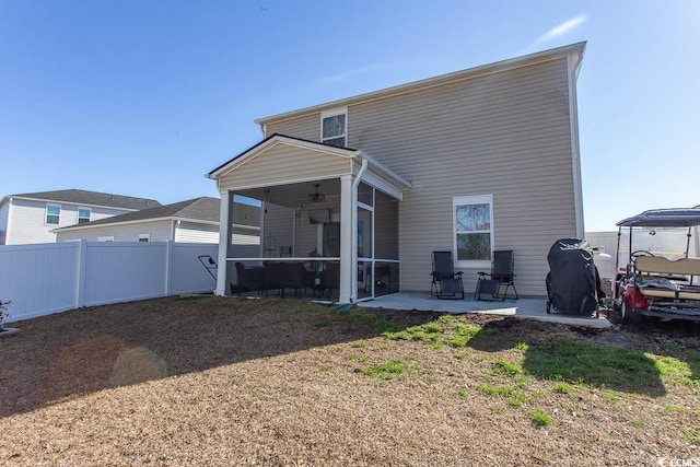 rear view of property with a patio and a sunroom