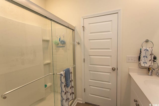 bathroom featuring vanity and a shower with shower door