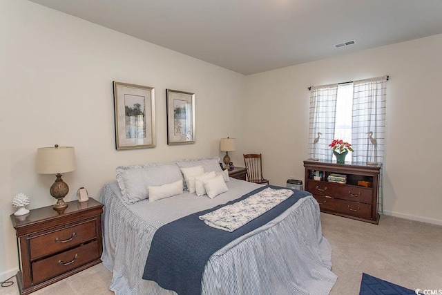 bedroom featuring light colored carpet