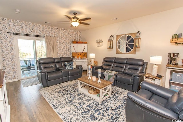 living room with hardwood / wood-style flooring and ceiling fan