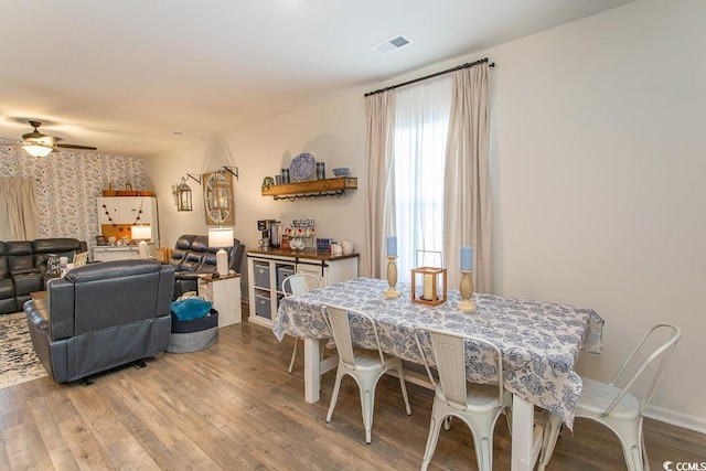 dining room featuring ceiling fan and light hardwood / wood-style flooring