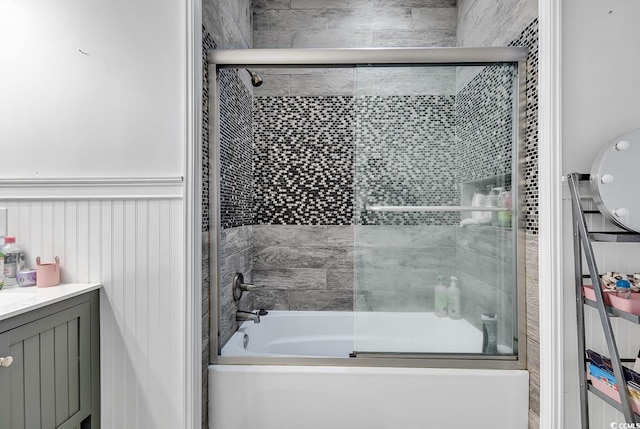 bathroom featuring vanity and bath / shower combo with glass door