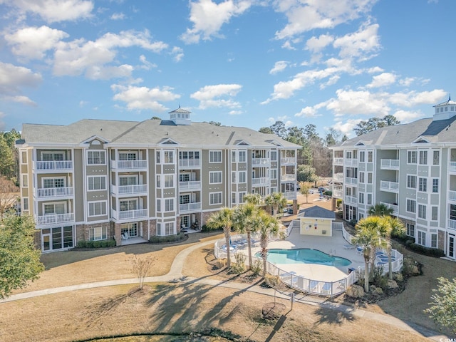 view of building exterior featuring a community pool