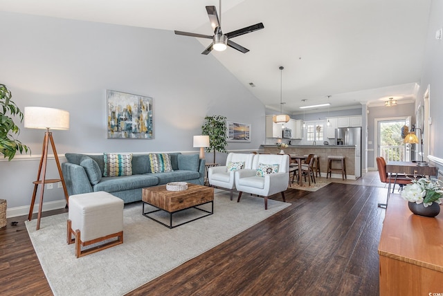 living room with ceiling fan, dark hardwood / wood-style floors, and high vaulted ceiling