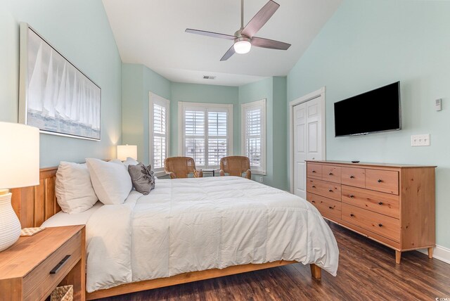 bedroom with ceiling fan, lofted ceiling, dark hardwood / wood-style flooring, and a closet