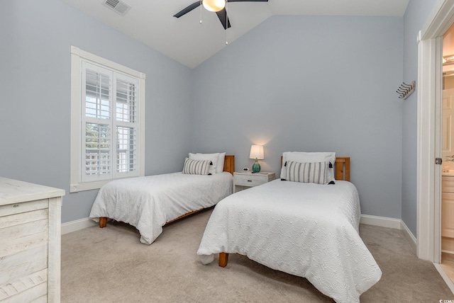 bedroom featuring vaulted ceiling, connected bathroom, light colored carpet, and ceiling fan