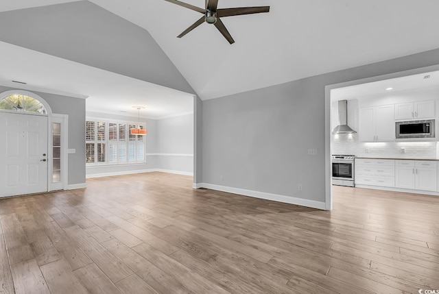 unfurnished living room with lofted ceiling, ceiling fan, and light hardwood / wood-style flooring