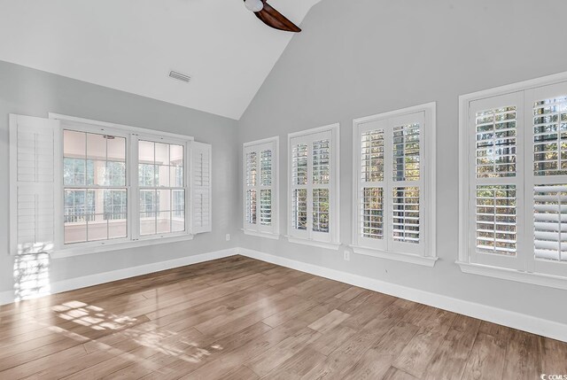 unfurnished sunroom with vaulted ceiling and ceiling fan