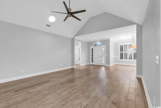 unfurnished living room with visible vents, ceiling fan, light wood-style flooring, and baseboards