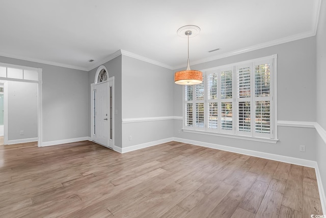 unfurnished dining area with light wood finished floors, baseboards, and crown molding