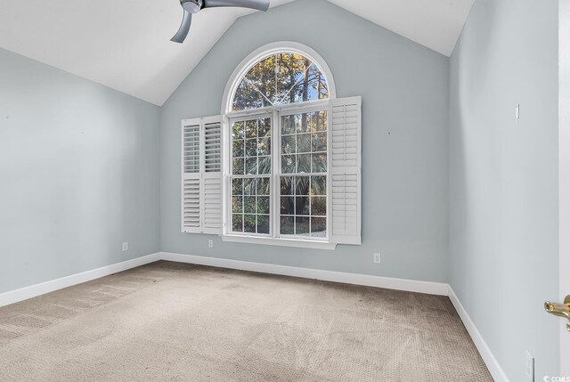 carpeted empty room featuring vaulted ceiling and ceiling fan