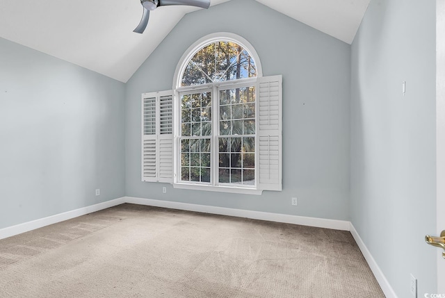 spare room with a ceiling fan, lofted ceiling, carpet flooring, and baseboards