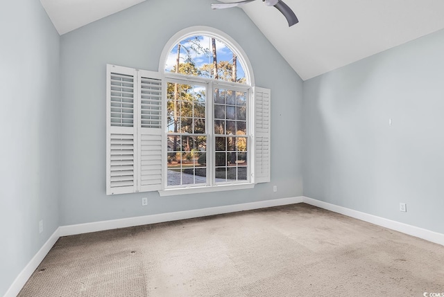 unfurnished room with lofted ceiling, carpet flooring, a ceiling fan, and baseboards